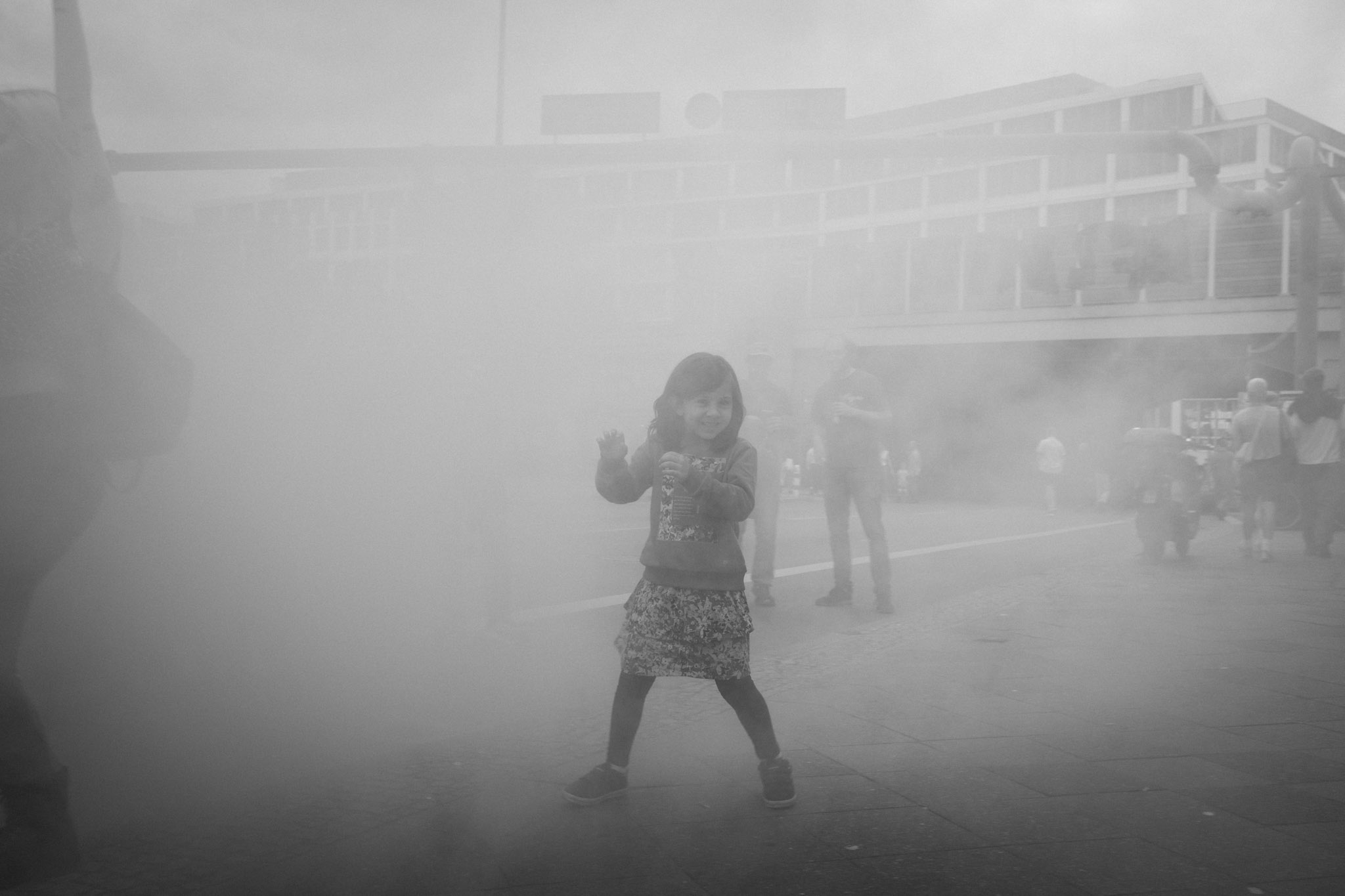 A child emerging through smoke during the A100 Wegbassen protest in Berlin