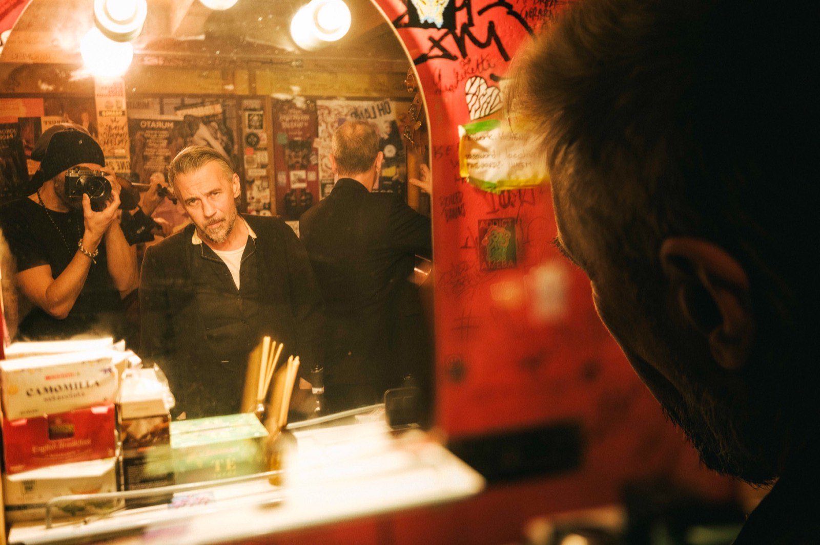 Quintorigo backstage in Bologna, reflected in a dressing-room mirror